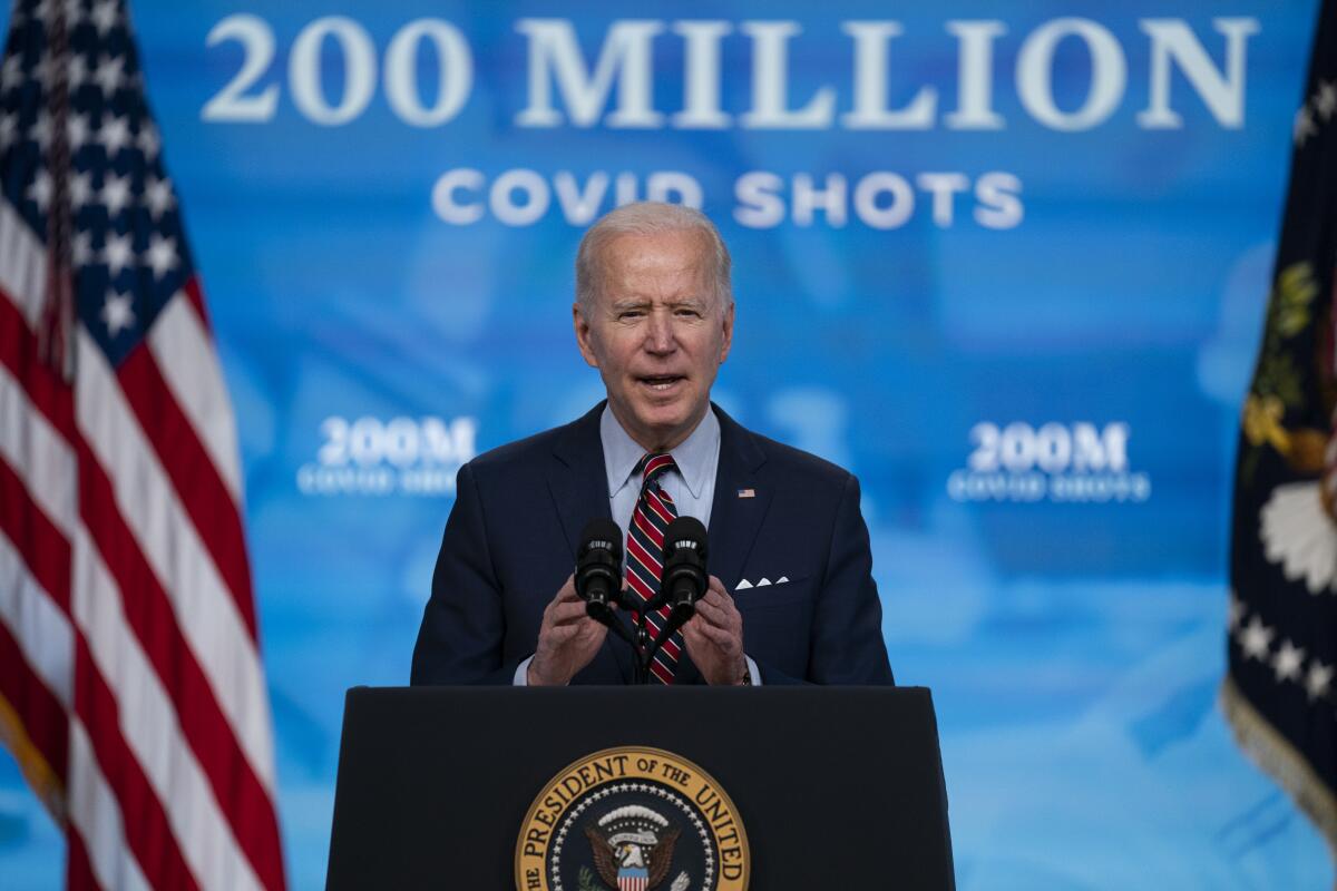 Biden speaks at a podium that has the presidential seal.