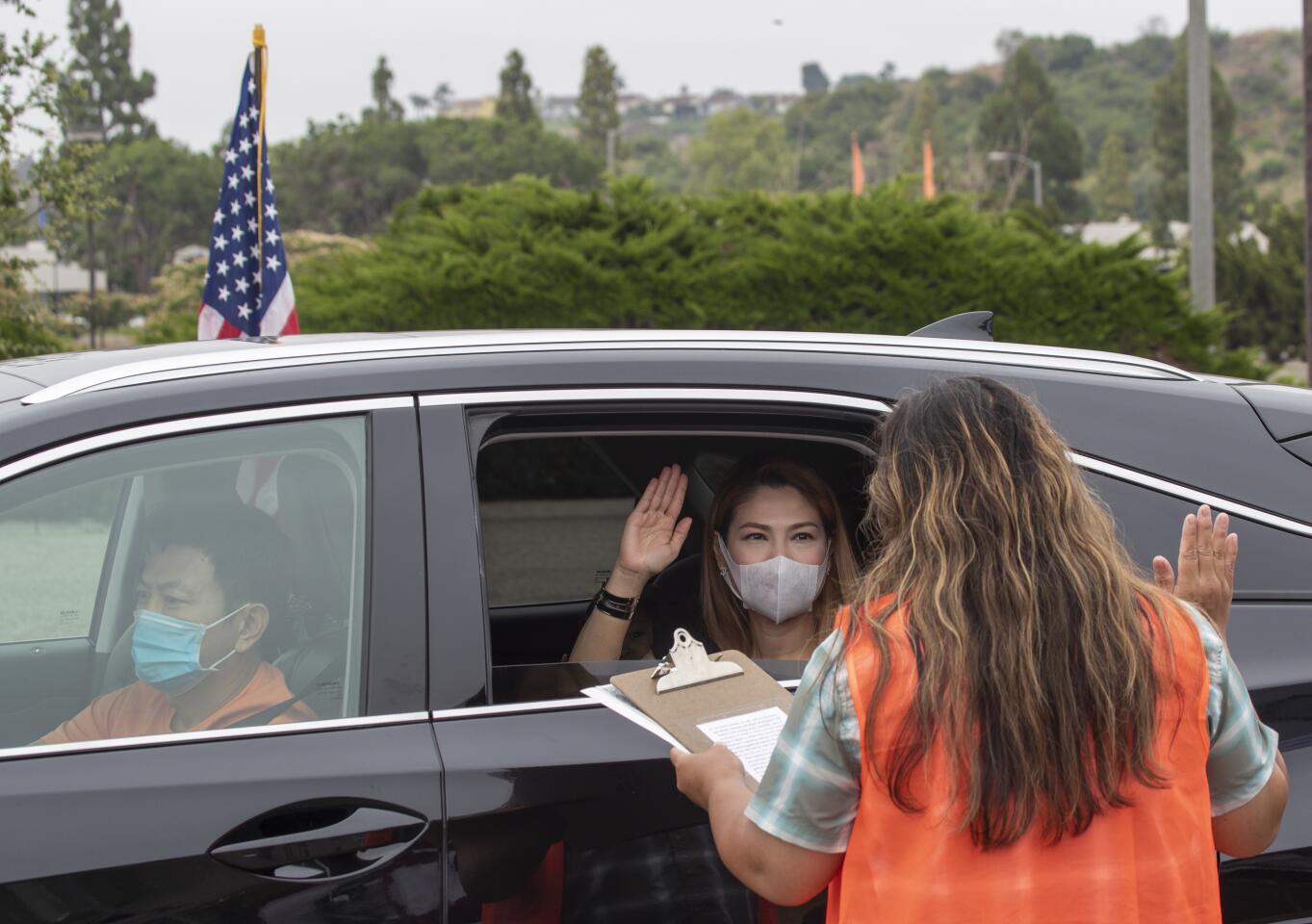 U.S. citizenship officer Rochelle Reyes, right, administers the oath of allegiance to Thao Pham in Laguna Niguel.