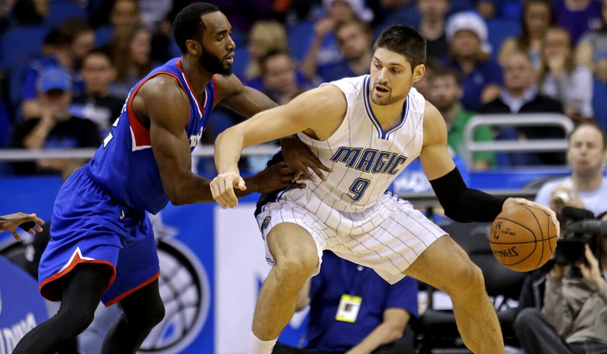 Orlando's Nikola Vucevic, right, has become a double-double threat for the Magic, averaging 18 points and 11 rebounds this season.