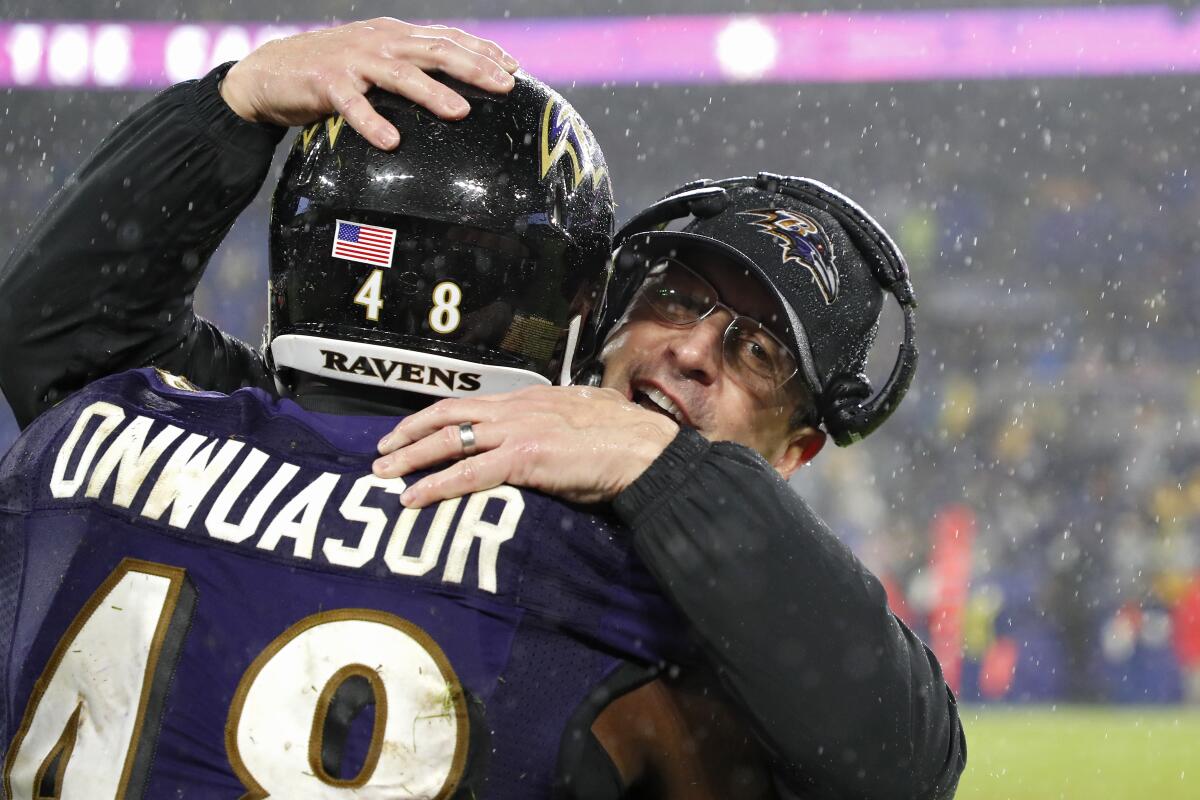 Baltimore Ravens coach John Harbaugh celebrates with inside linebacker Patrick Onwuasor during Sunday's win over the Pittsburgh Steelers.