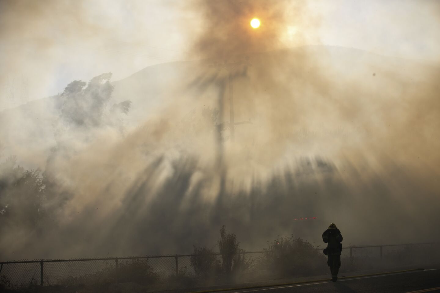Firefighters work to extinguish flames on Cajon Blvd along the interstate 15, in San Bernardino County on Aug. 17.