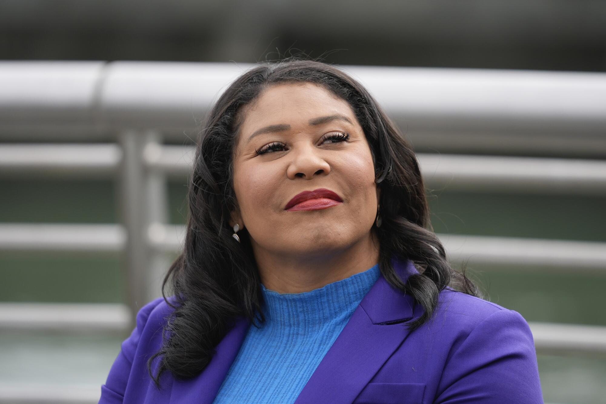 San Francisco Mayor London Breed smiles, sitting along the city's waterfront.