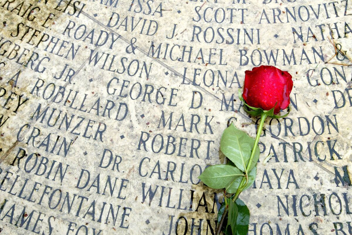 A rose lies on a memorial with engraved names of AIDS victims in 2003 at the National Aids Memorial Grove in San Francisco. (Justin Sullivan / Getty Images)