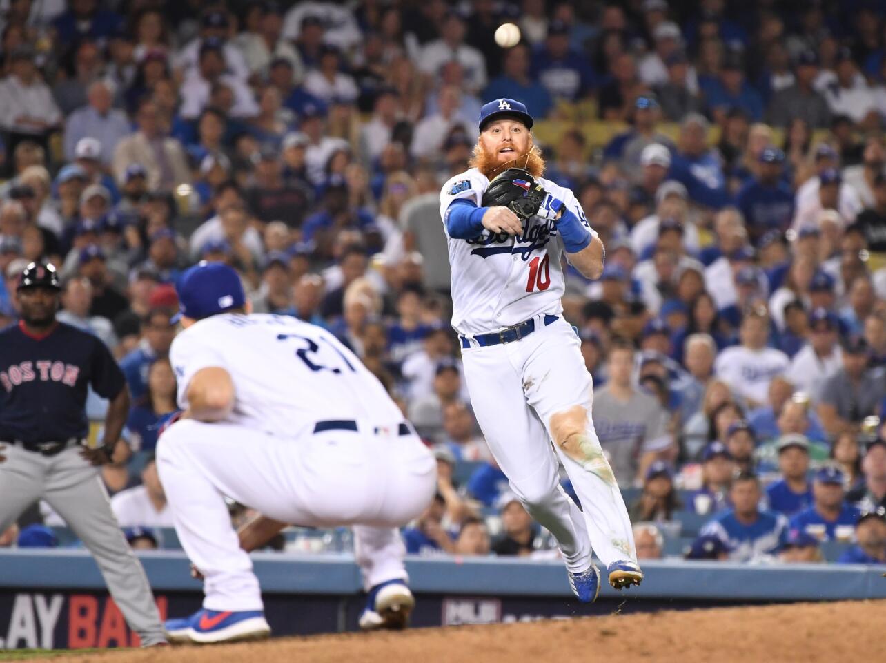 Dodgers 3rd baseman Justin Turner throws over pitcher Walker Buehler to throw Red Sox's Blake Swihart out in the 6th inning.