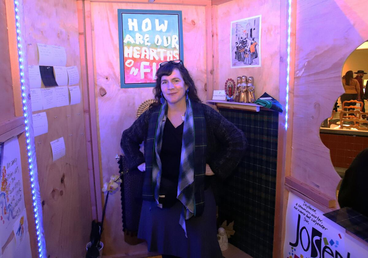 Artist Lexa Walsh poses in the Sisters InfoShop art installation.