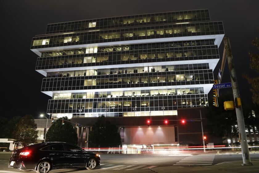 FILE - In this Thursday, Sept. 12, 2019, file photo, cars pass Purdue Pharma headquarters in Stamford, Conn. A new court filing shows that the wealthy owners of OxyContin maker Purdue Pharma started taking far more money out of the company after it was fined in 2007 for misleading marketing of the powerful prescription painkiller. (AP Photo/Frank Franklin II, File)