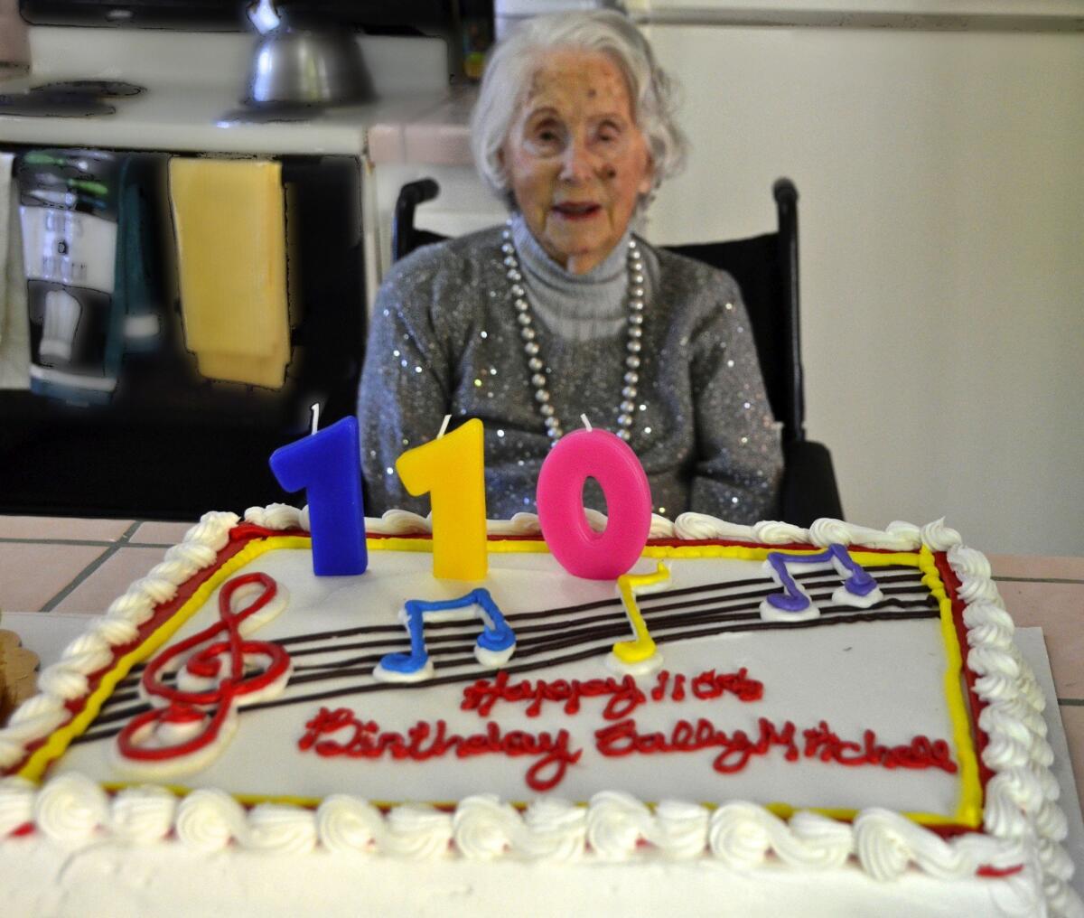 Sally Mitchell admires her cake as she celebrates her 110th birthday on Nov. 25, 2014.