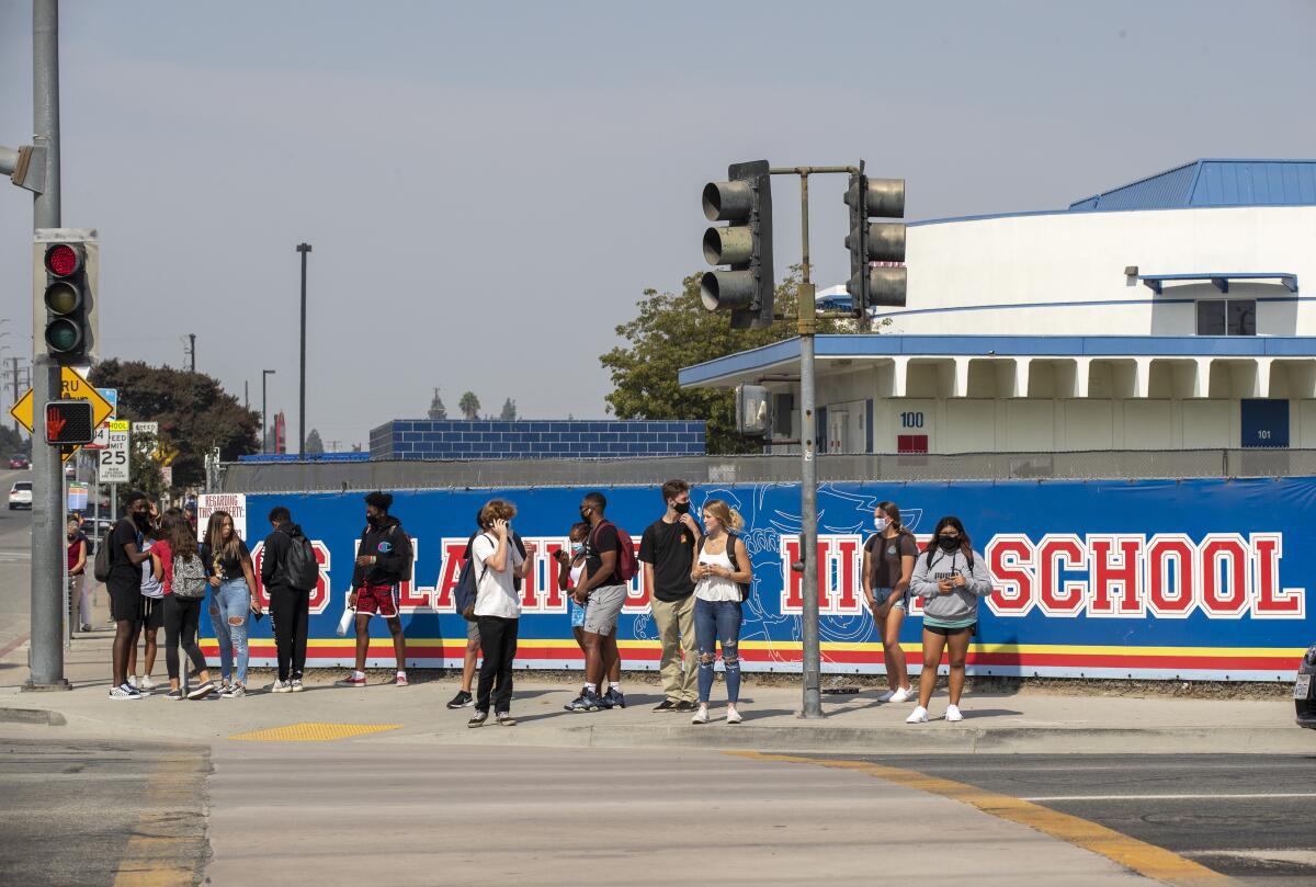  Students leave campus after a day of in-class learning at Los Alamitos High School.