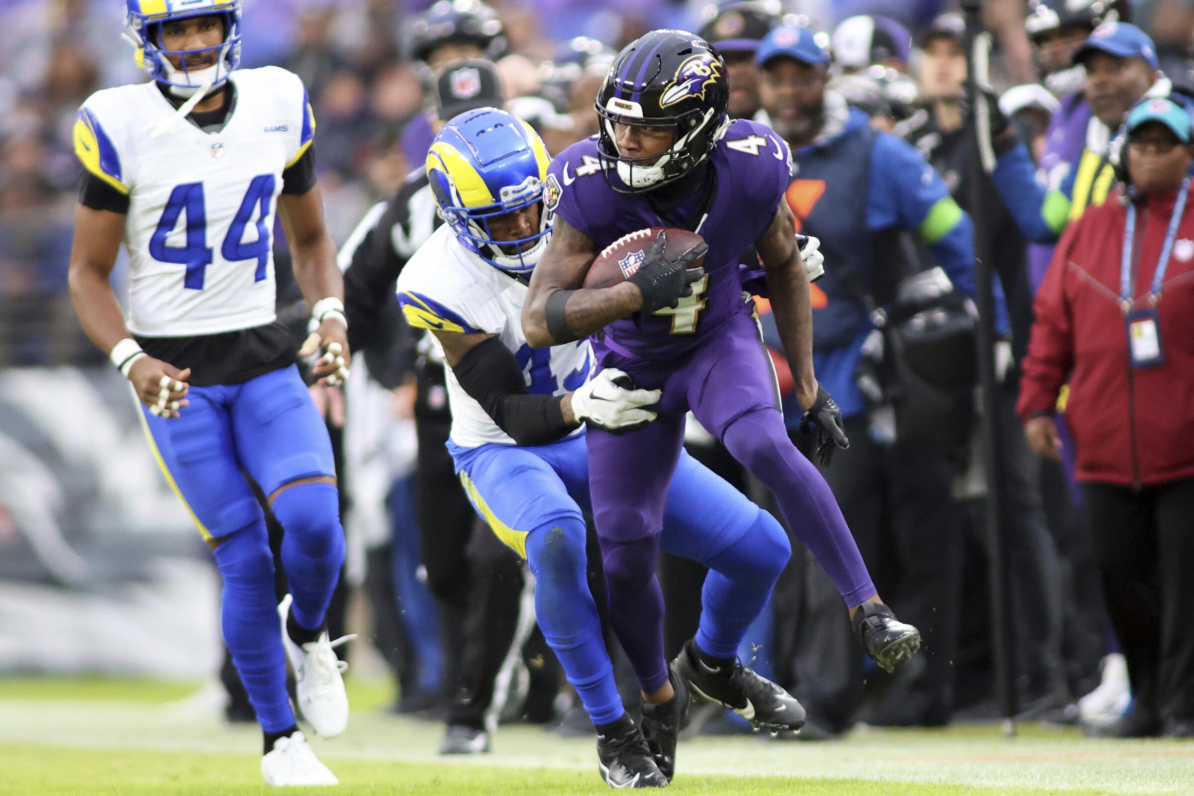 Ravens wide receiver Zay Flowers (4) runs after a catch against the Rams.