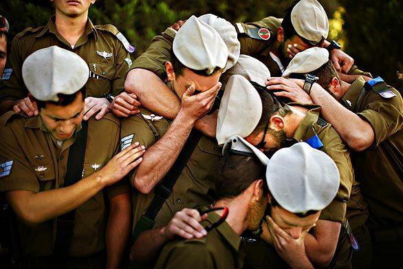 Israeli troops mourn a colleague, army Staff Sgt. Alex Mashavisky, at his funeral in the southern city of Beersheba. Mashavisky was among those who died in the conflict with Hamas militants in the Gaza Strip.