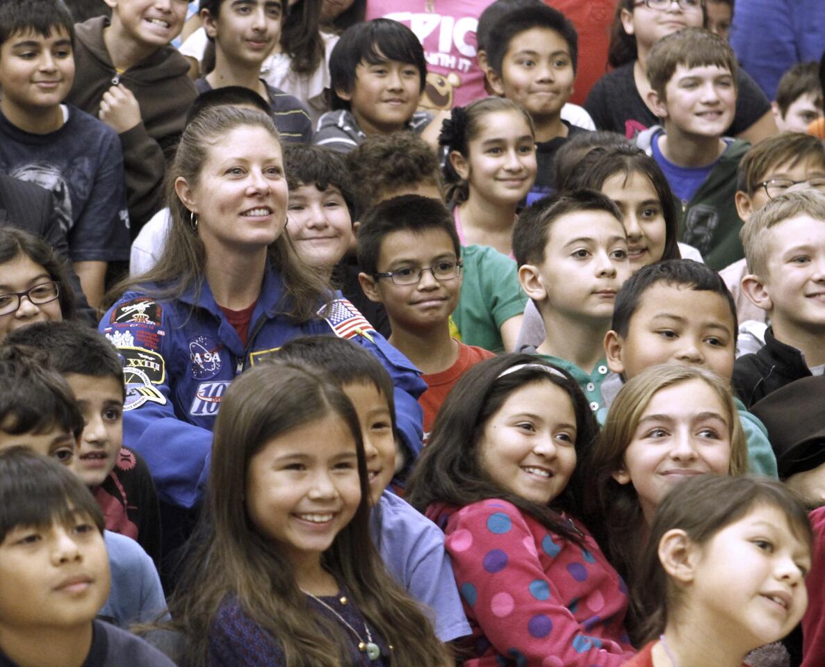 La Crescenta Elementary School students pose with NASA astronaut Tracy Caldwell Dyson after she spoke about her career and time spent in space, at the La Crescenta school on Thursday, January 23, 2014. Caldwell Dyson encouranged the students to stay smart and do what they like to do.