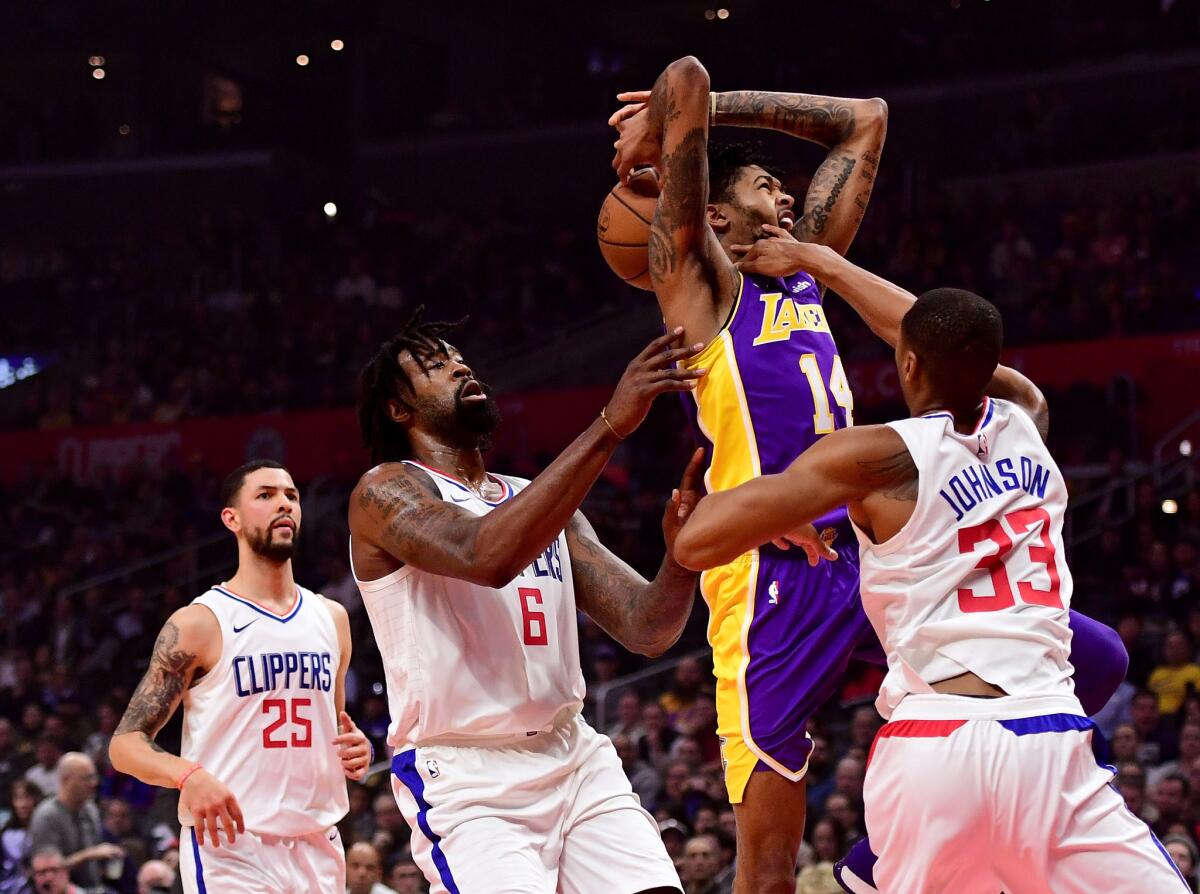 LOS ANGELES, CA - NOVEMBER 27: Brandon Ingram #14 of the Los Angeles Lakers is fouled by Wesley Johnson #33 of the LA Clippers as he drives to the basket during the first half at Staples Center on November 27, 2017 in Los Angeles, California.