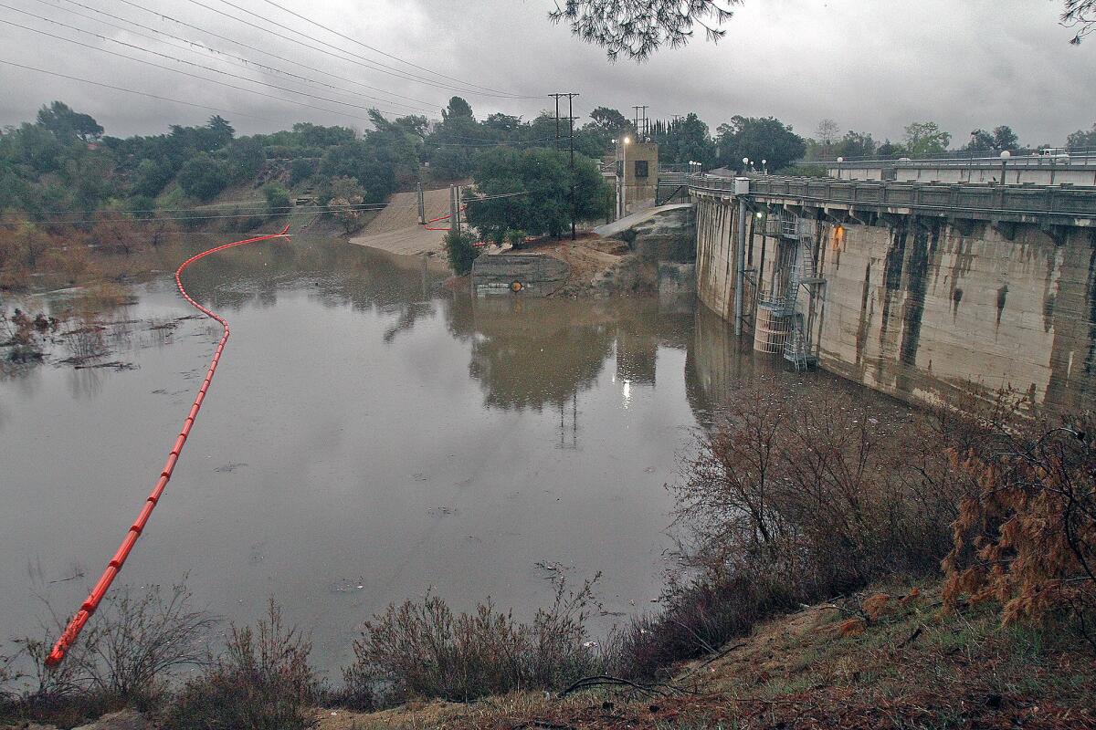 Devil's Gate Dam holds the rising Hahamongna watershed waters in check during the rain in Pasadena on Friday, Feb. 28, 2014.