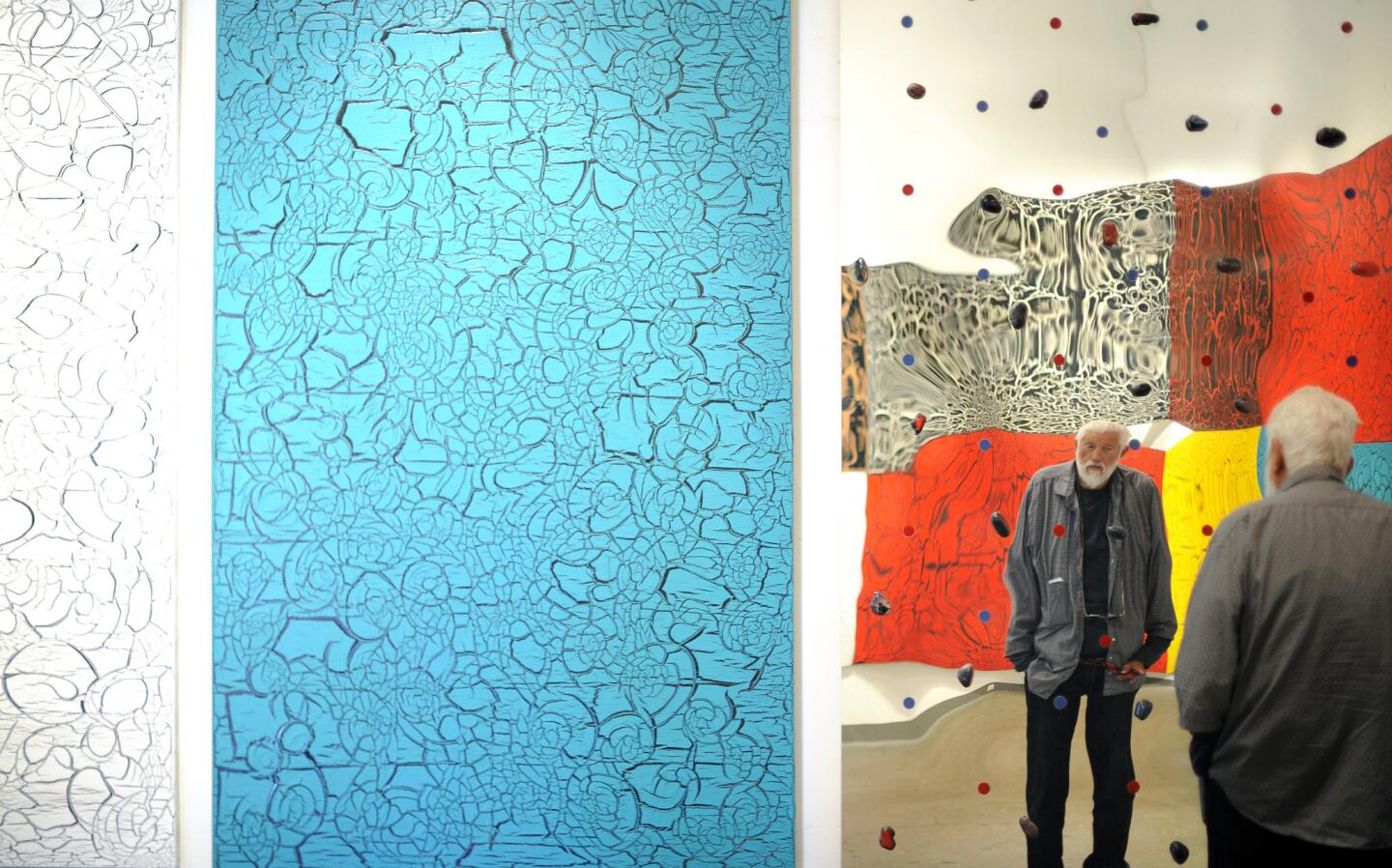 Artist Ed Moses is photographed at his home studio in Venice with his craquelure panels at left.