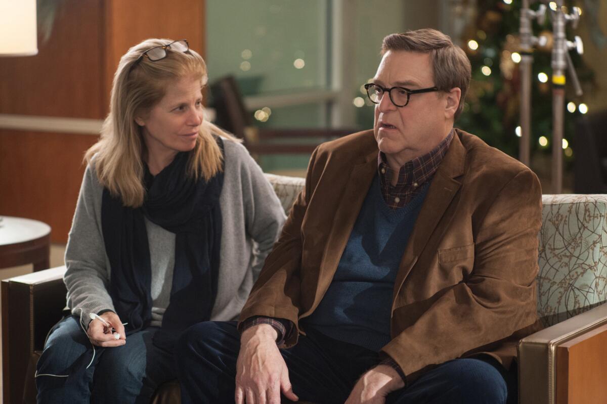 Director Jessie Nelson, left, and actor John Goodman are photographed on the set of the film "Love the Coopers."