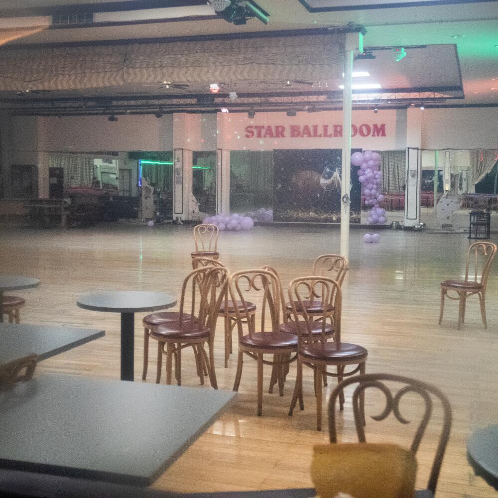 Empty tables and chairs inside the Star Ballroom Dance Studio