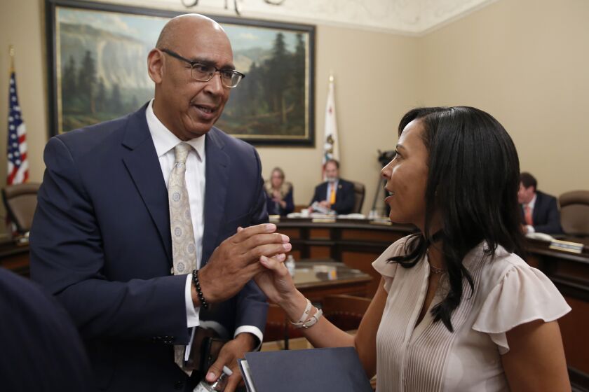 FILE - Democratic Assembly members Chris Holden, of Pasadena, left, and Autumn Burke.