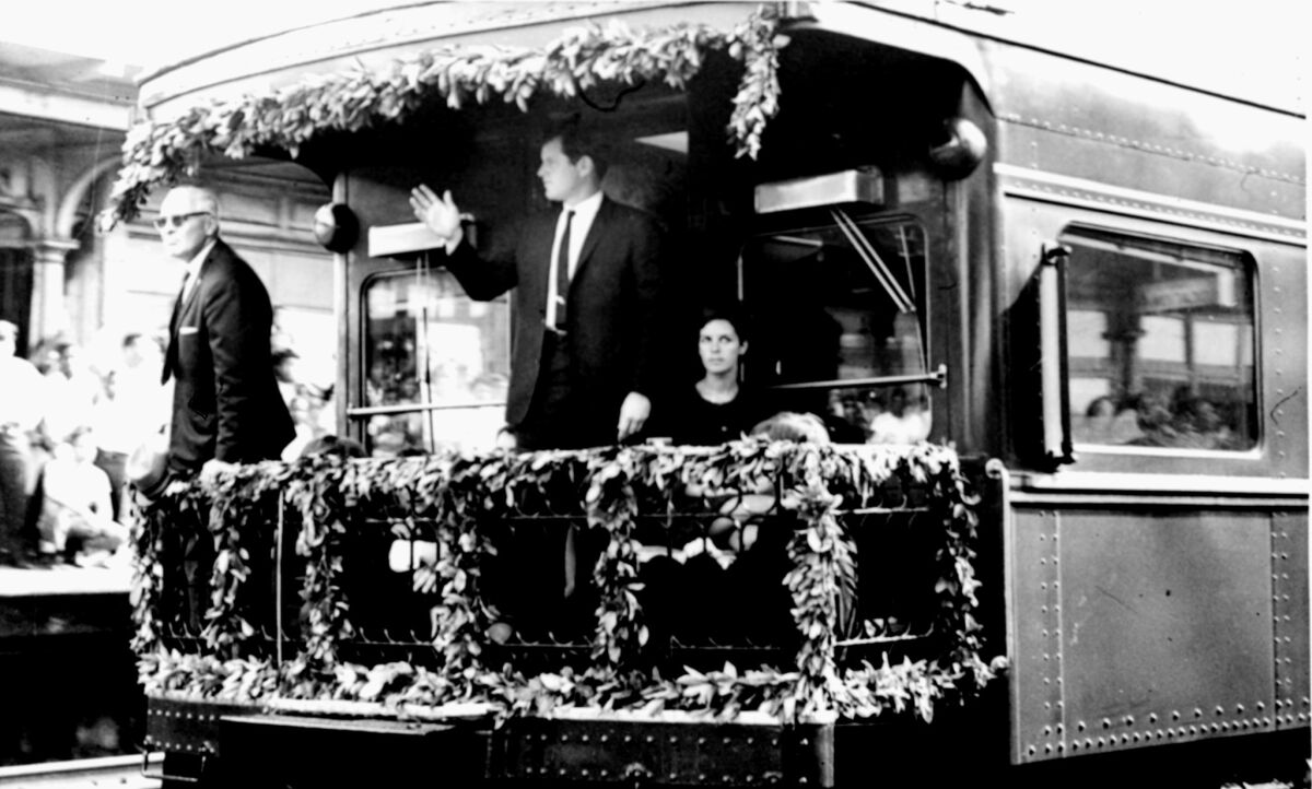 Sen. Edward M. Kennedy stands on the rear platform of the funeral train bearing the body of Sen. Robert F. Kennedy. 