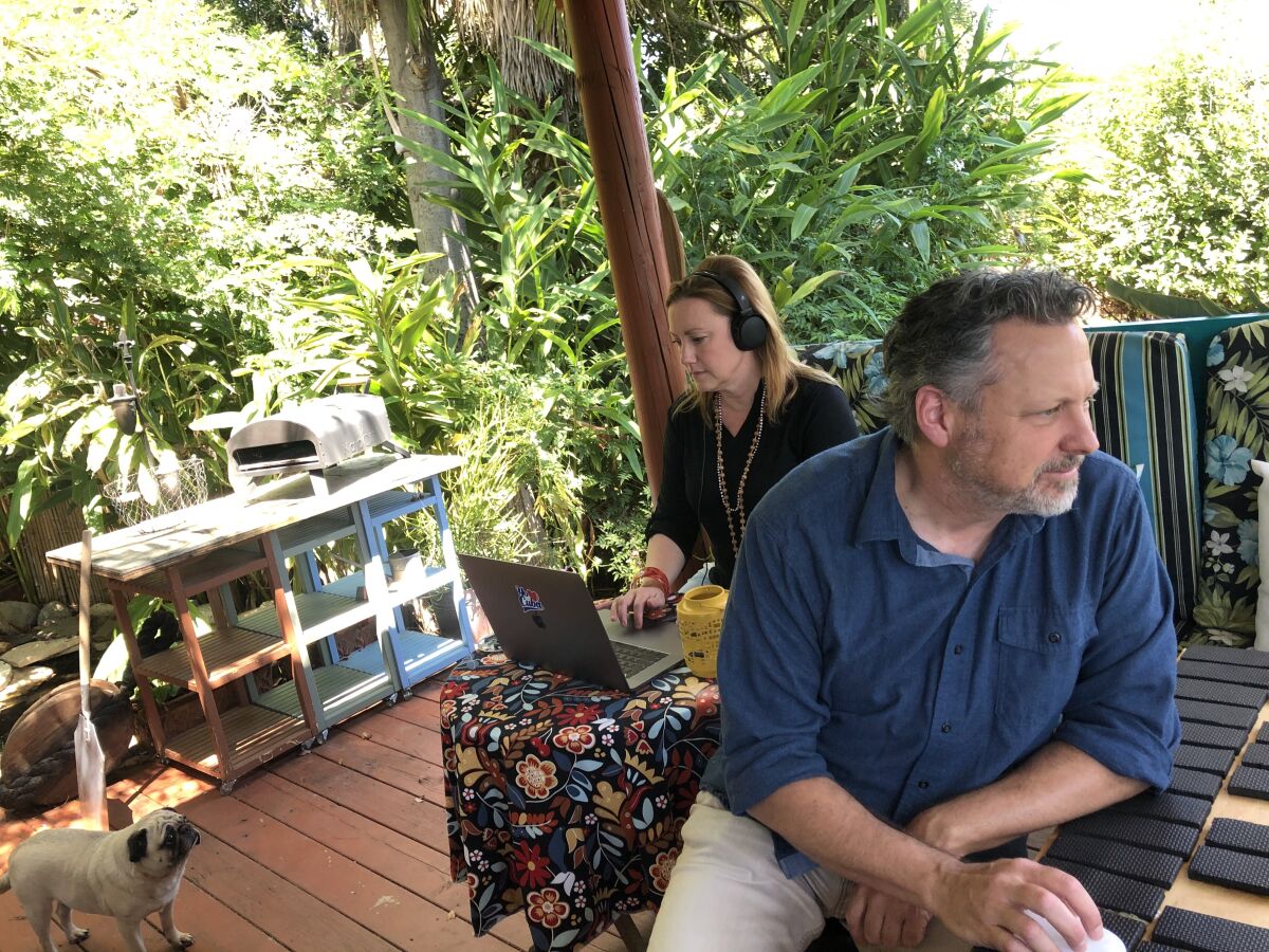 Matthew Armstrong and Courtney Corey work from home in their Escondido backyard hut.