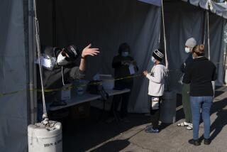 A healthcare worker waves his hand as he calls up the next person in line at a COVID-19 testing site operated by CORE in Los Angeles, Tuesday, Jan. 4, 2022. California is starting to feel the full wrath of the omicron variant. Hospitalizations have jumped nearly 50% since Christmas and models show that in a month the state could have 22,000 people in hospitals, which was the peak during last winter's epic surge. (AP Photo/Jae C. Hong)