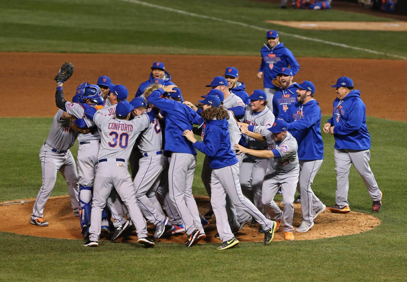 Oct 21, 2015; Chicago, IL, USA; New York Mets players celebrate on the field after defeating the Chicago Cubs in game four of the NLCS at Wrigley Field. Mandatory Credit: Aaron Doster-USA TODAY Sports ** Usable by SD ONLY **