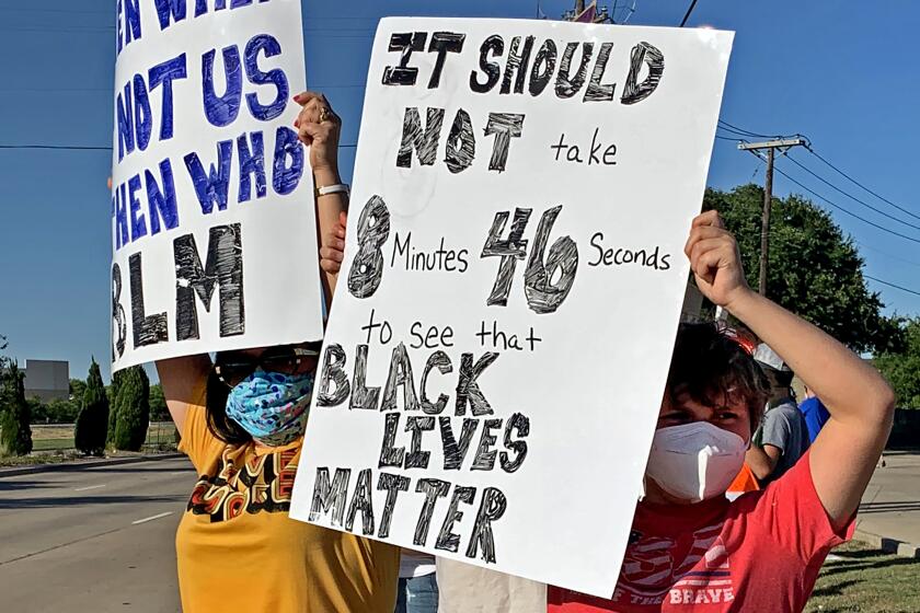 Mike Sexton's wife and son, Lee Anne, left, and Tyler, 11, during a unity rally outside Grapevine, Texas, that Sexton organized to protest excessive use of force and racial bias in policing. (Courtesy of Mike Sexton)