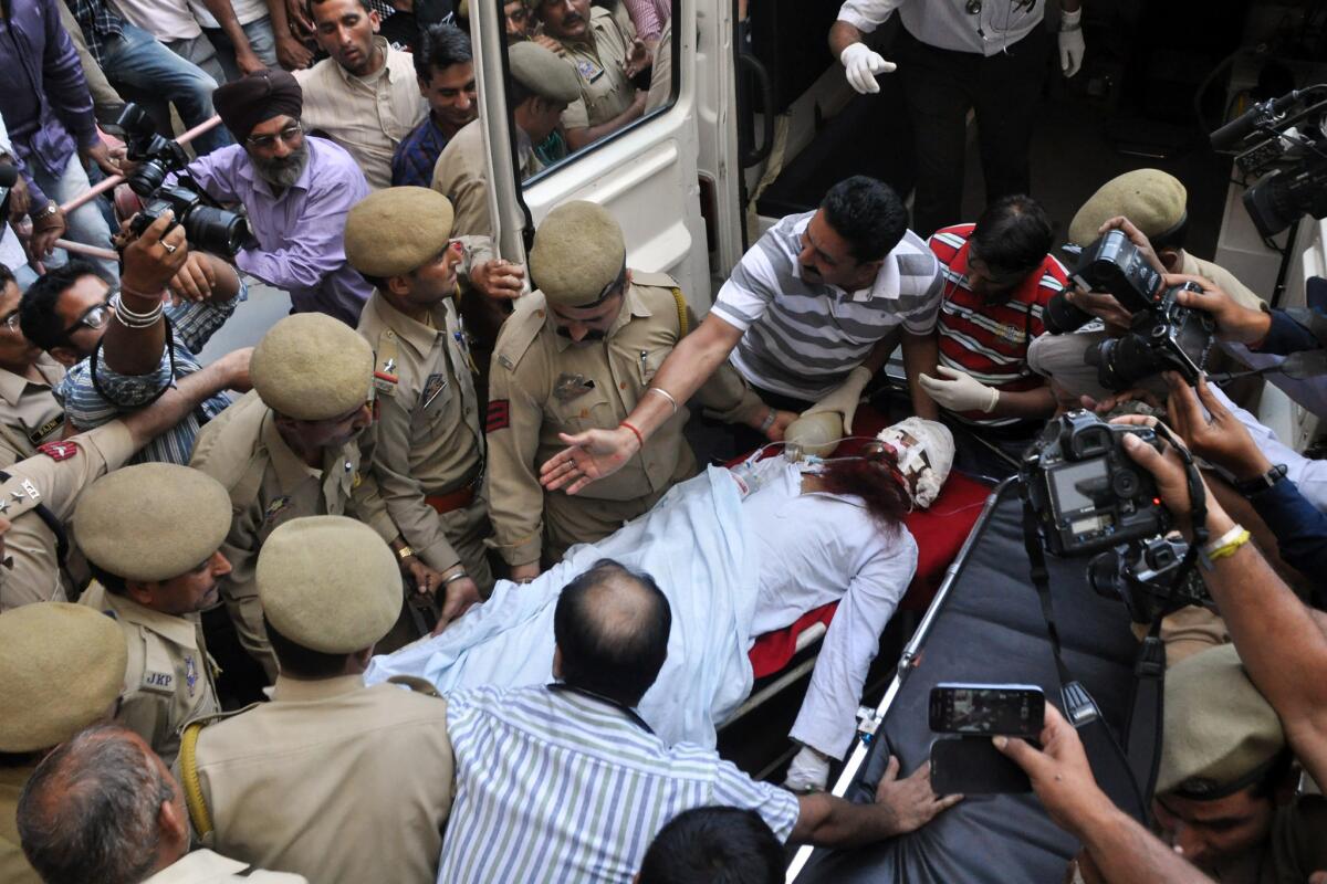 Pakistani prisoner Sanaullah Haq, attacked in an Indian prison, is carried to an ambulance in Jammu.