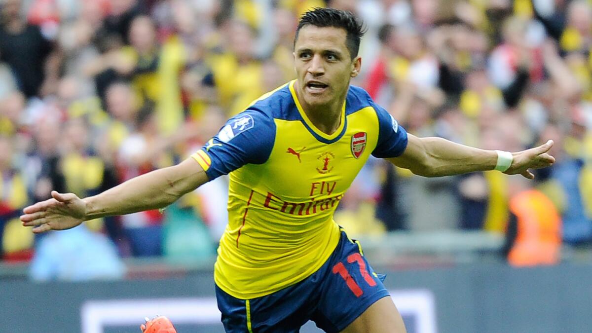 Arsenal's Alexis Sanchez celebrates after scoring during a 4-0 victory over Aston Villa for the FA Cup title on Saturday.