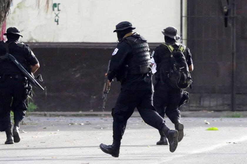 Police forces confront anti-government demonstrators at Monimbo neighbourhood in Masaya, some 35 km from Managua, on July 13, 2018 during a 24-hour general strike called by the opposition. In the afternoon, Nicaraguan President Daniel Ortega and his supporters began a procession from the capital to the opposition stronghold of Masaya to commemorate a significant event in the president's coming to power in 1979, known as the "The Retreat". The military maneuver allowed the Sandinista guerrilla forces to regroup and later overthrow the dictatorship of Anastasio Somoza in 1979. / AFP PHOTO / Inti OCONINTI OCON/AFP/Getty Images ** OUTS - ELSENT, FPG, CM - OUTS * NM, PH, VA if sourced by CT, LA or MoD **