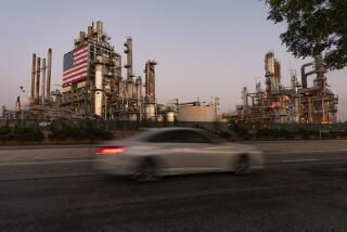 FILE - A car drives past Marathon Oil's Los Angeles Refinery complex in Carson, Calif., May 29, 2024. Gas prices are once again on the decline across the U.S. — bringing some ease to drivers now paying a little less to fill up their tanks. (AP Photo/Damian Dovarganes, File)