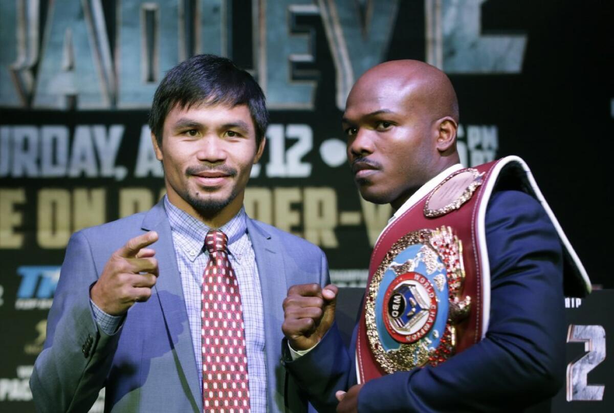 Manny Pacquiao, left, poses with Timothy Bradley on Feb. 6.