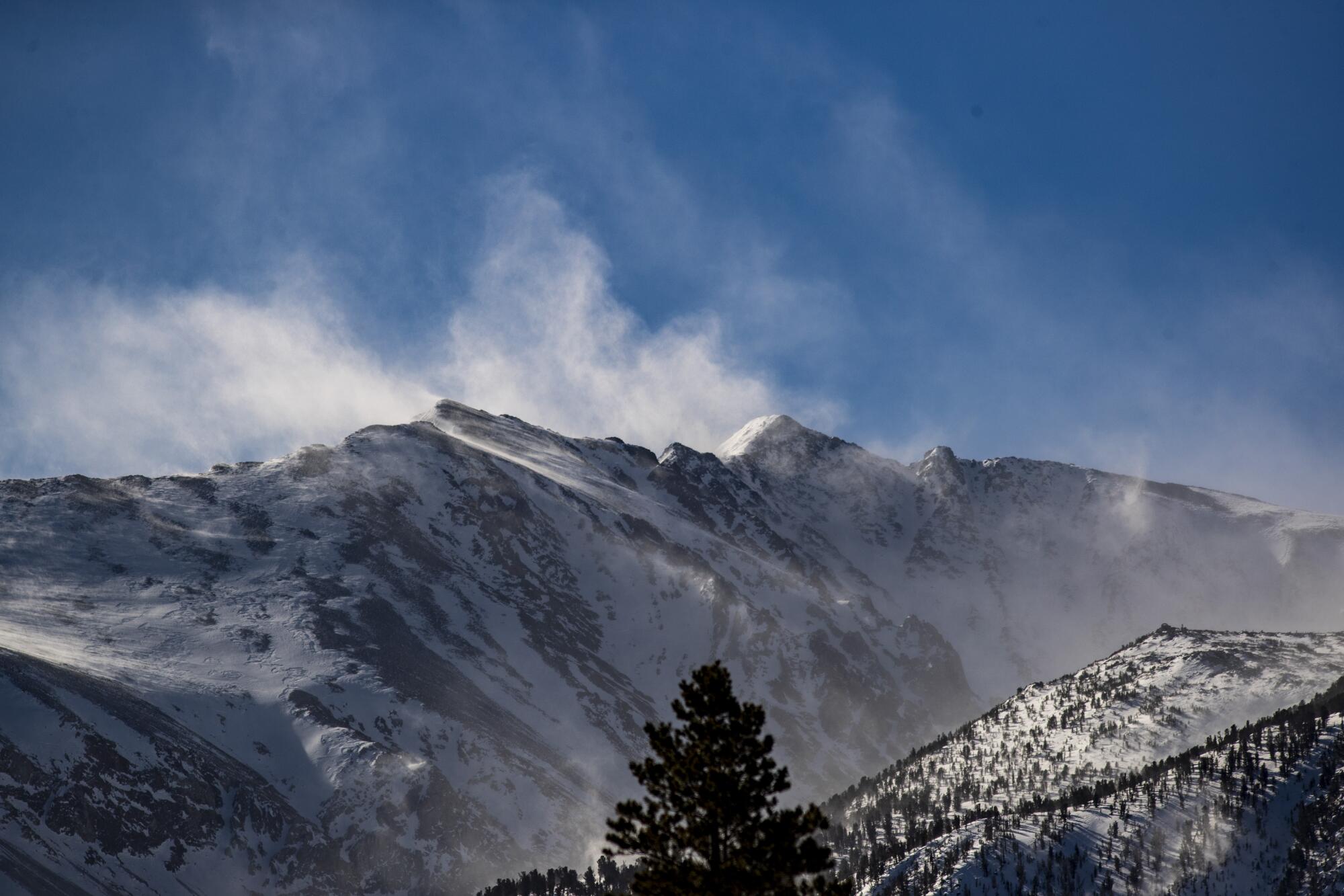 Snow is blown off the mountains