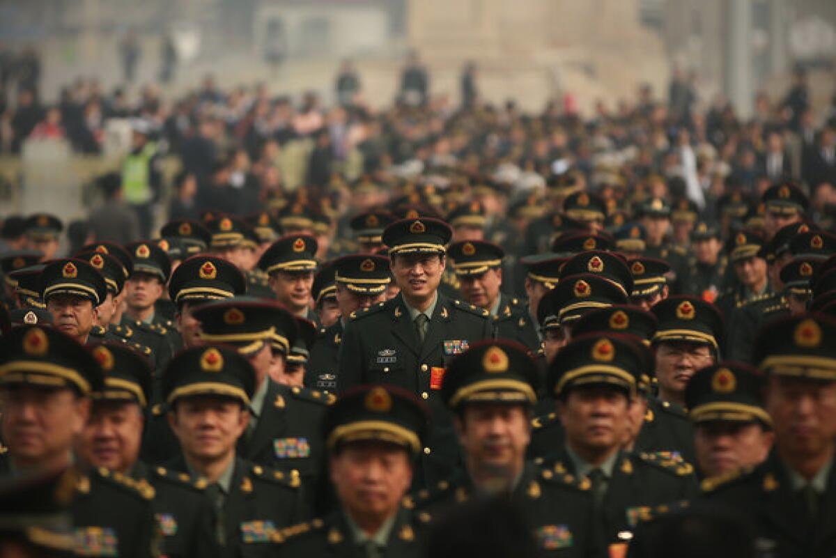 Delegates from Chinese People's Liberation Army march from Tiananmen Square to the Great Hall of the People to attend a plenary session of the National People's Congress during severe pollution in Beijing, China.