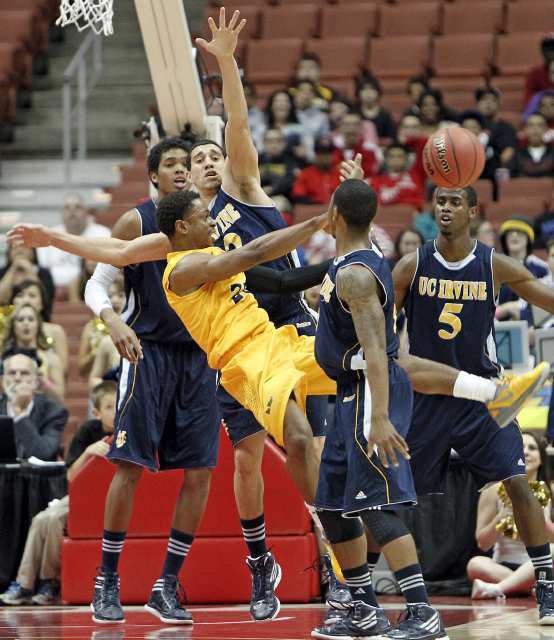 UC Irvine's Daman Starring (with hand up) forces Long Beach State's Casper Ware to pass the ball.