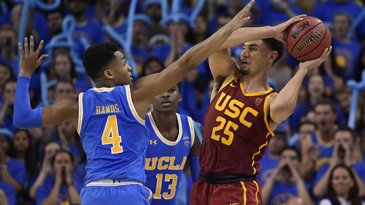 USC forward Bennie Boatwright, right, tries to pass as UCLA guard Jaylen Hands defends during the second half on Thursday. UCLA won 93-88 in overtime.
