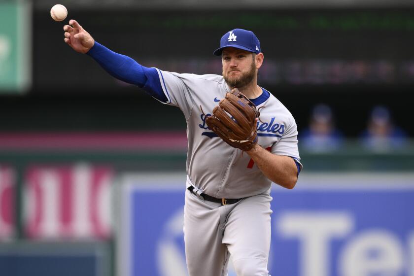 Los Angeles Dodgers second baseman Max Muncy throws to first.
