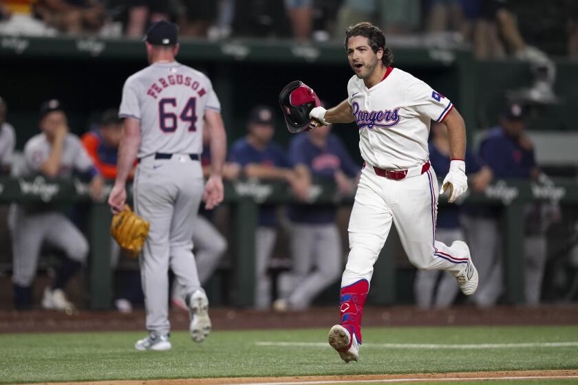 Josh Smith, derecha, de los Rangers de Texas, corre las bases después de batear cuadrangular de dos carreras para dejar tendidos en el terreno a los Astros de Houston en la 10ma entrada del juego de béisbol del lunes 5 de agosto de 2024, en Arlington, Texas. (AP Foto/Sam Hodde)