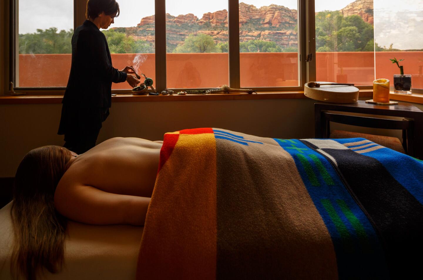 In one of many treatment rooms, a guest enjoys a view of the canyon while awaiting the Inner Quest treatment. The therapist is burning sage to cleanse the energy in the room.