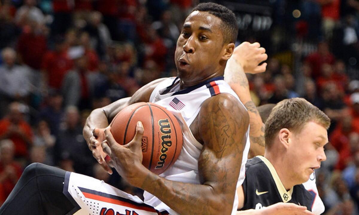 Arizona's Rondae Hollis-Jefferson grabs a rebound in front of Colorado's Ben Mills during the Wildcats' victory in the semifinals of the Pac-12 tournament on Friday.