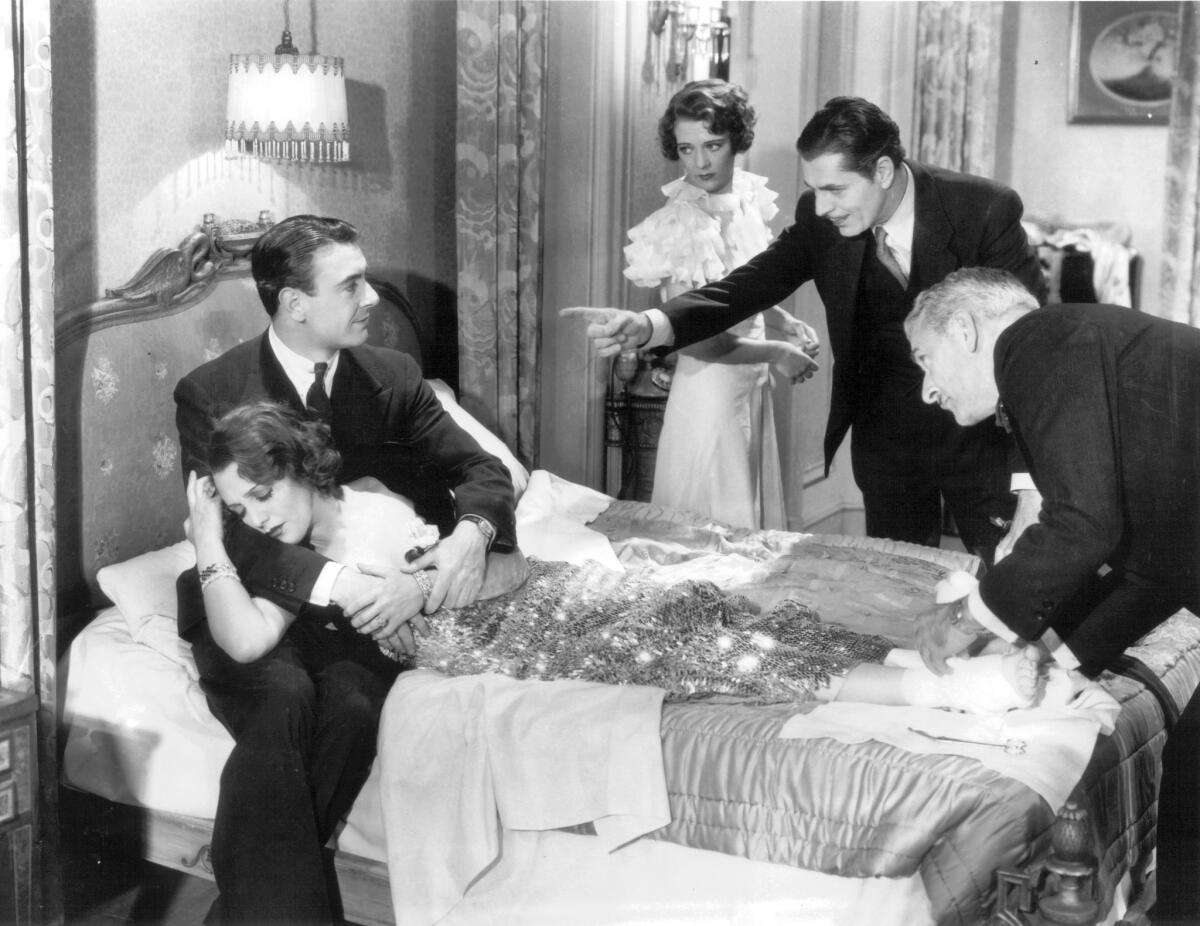 Bebe Daniels in the arms of George Brent as Ruby Keeler and Warner Baxter watch in "42nd Street," 1933.