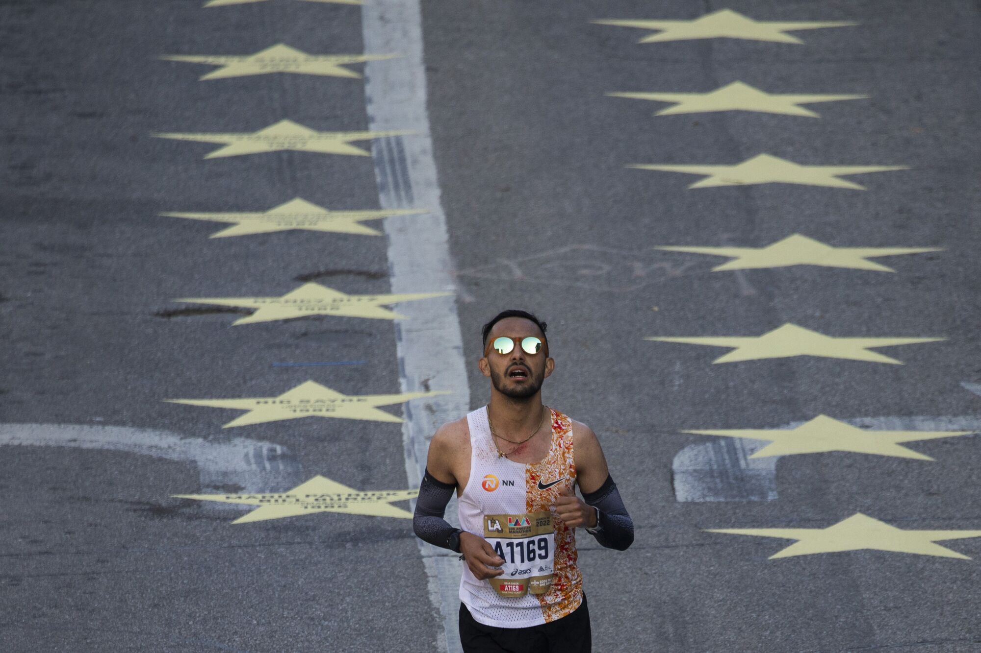  A runner crosses the finish line on Avenue of the Stars