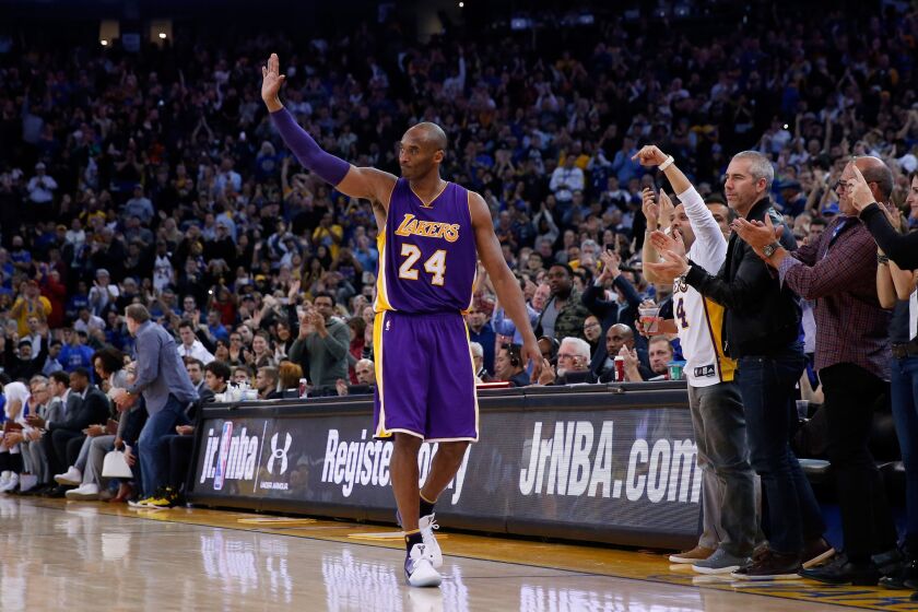 Lakers' Kobe Bryant waves to the crowd in Oakland after being taken out in the fourth quarter against the Golden State Warriors on Thursday.