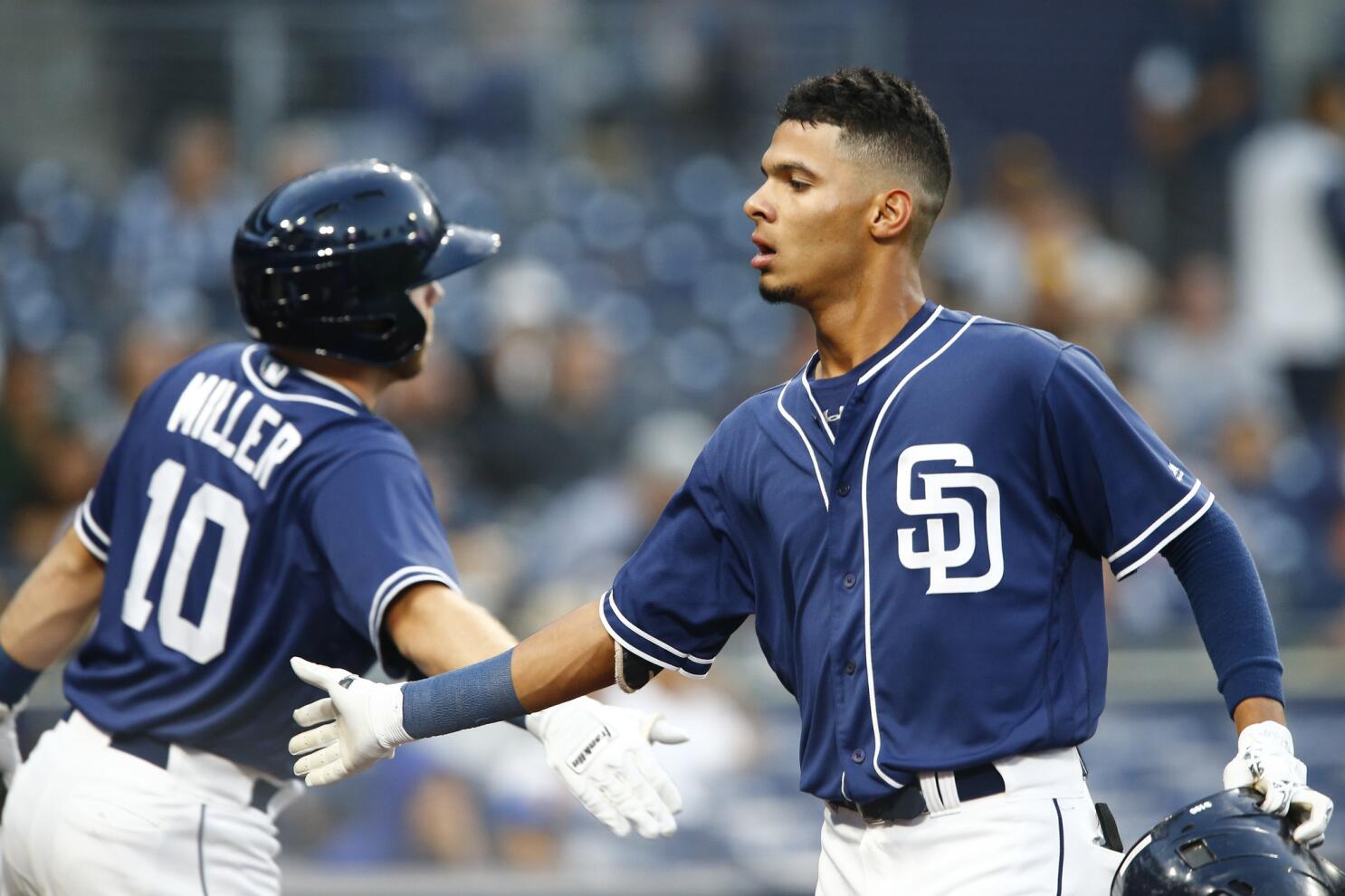 San Diego Padres shortstop Fernando Tatis Jr. holds his arm during the  eighth inning of a baseball game against the Los Angeles Dodgers Friday,  April 16, 2021, in San Diego. (AP Photo/Gregory