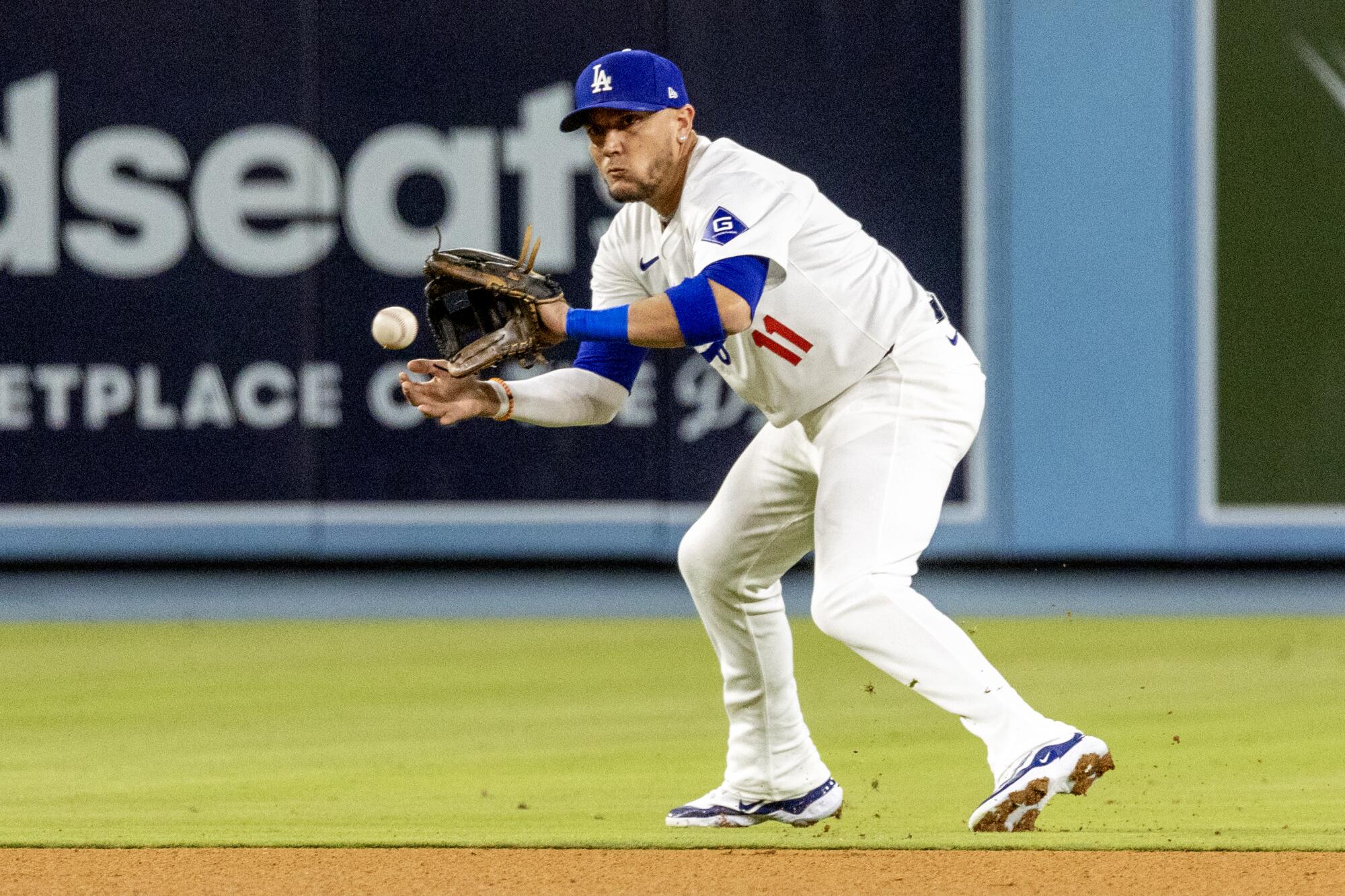 Dodgers shortstop Miguel Rojas fields the ball.