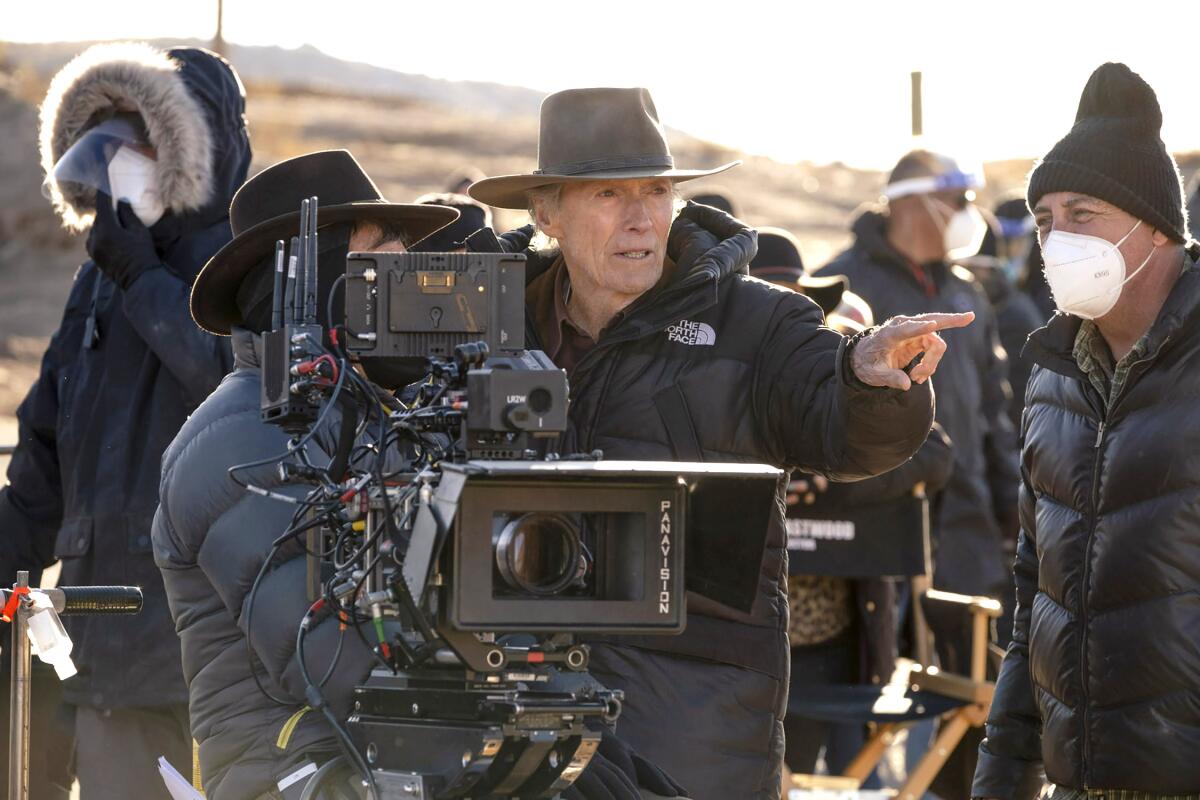 A man in a cowboy hat directs a film