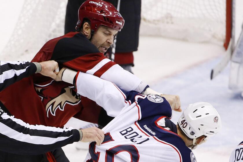 Coyotes enforcer John Scott, left, punches the Blue Jackets' Jared Boll (40) during a fight on Dec. 17, 2015.