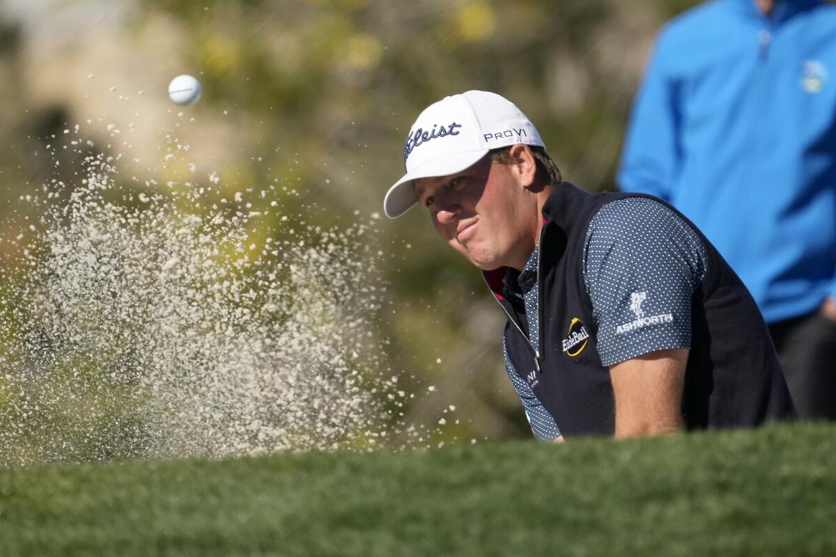 Tom Hoge hits out of the bunker onto the fifth green of the Pebble Beach Golf Links.