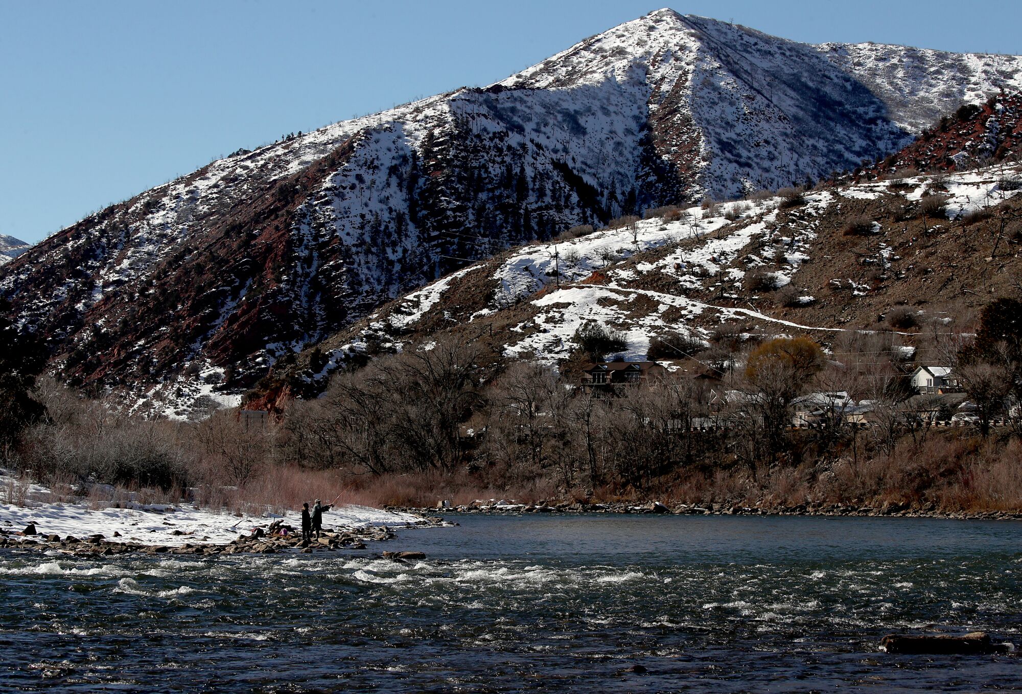 Fishermen cast their lines into the Colorado River in Glenwood Springs, where the Roaring Fork River meets the Colorado.
