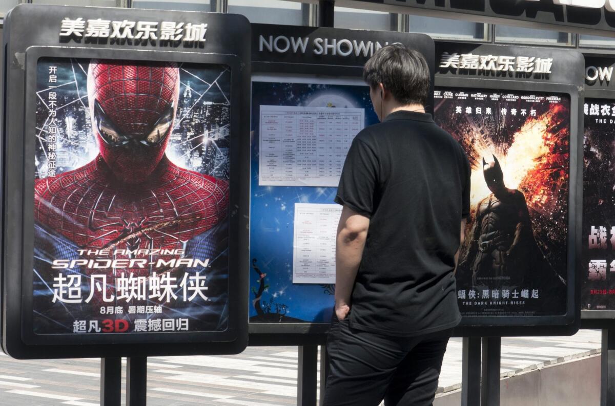 "The Amazing Spider-Man" and "The Dark Knight Rises" are advertised in Beijing.