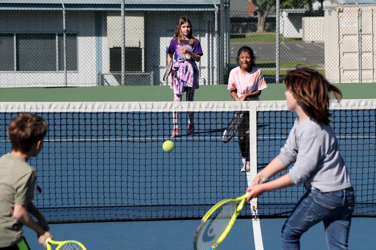 Kate Kensey and Camila Salas, top, play tennis with Grant Cummingham and Rockwell Tompkins bottom  Friday at Halecrest Park.